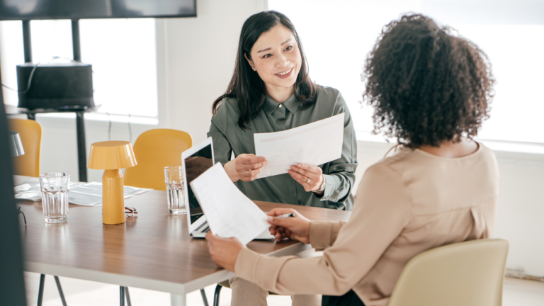 Women talking with paper